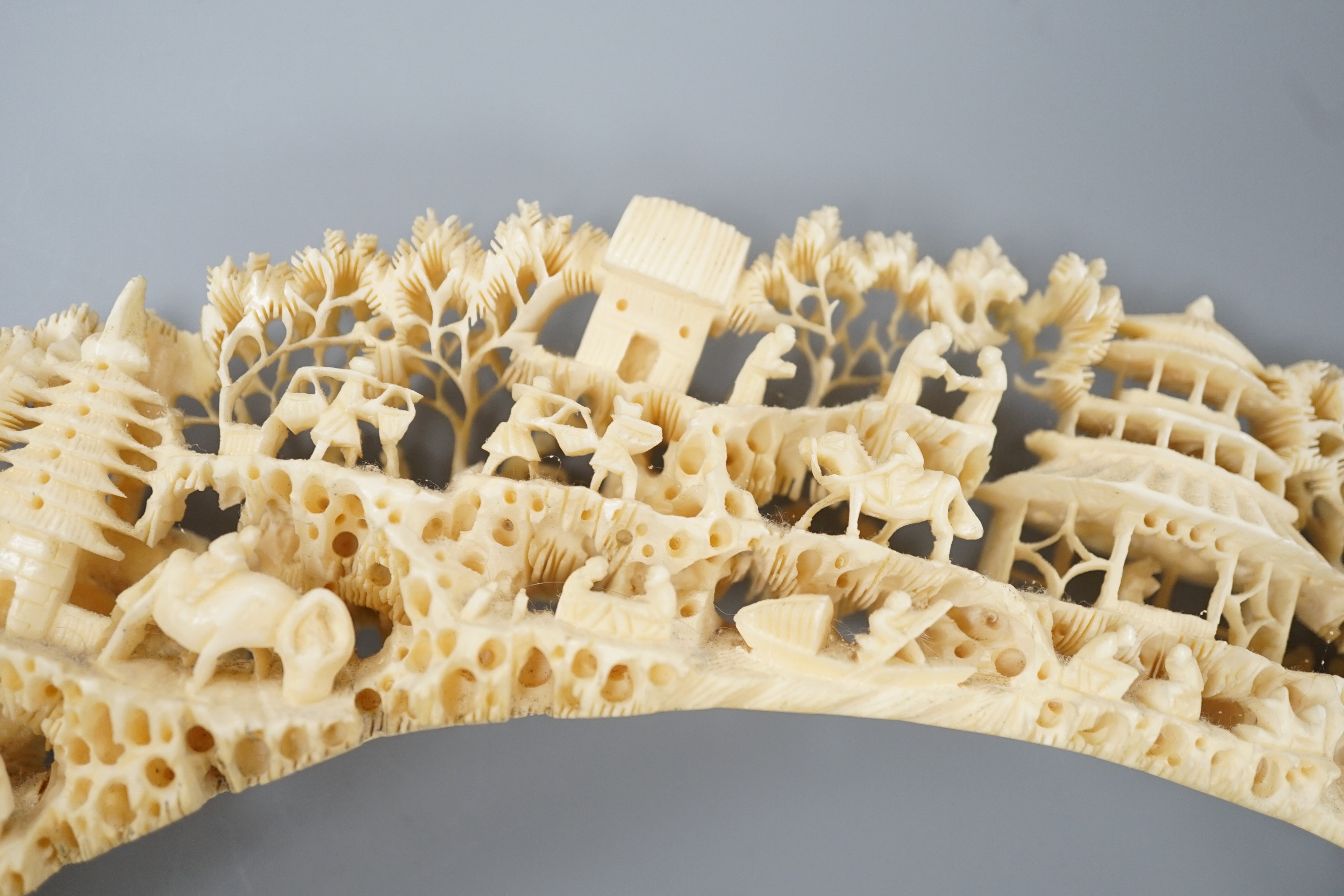 An early 20th century Chinese ivory ‘dragon’ box and cover, and a boar’s tusk carving of figures amid pavilions 40cm
